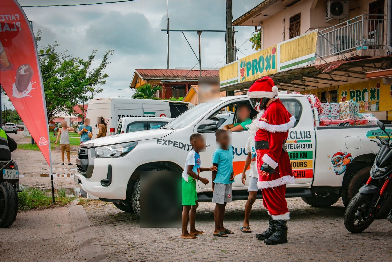 Père Noël motard à côté du pick-up F5.Club chargé de cadeaux — KdoRide